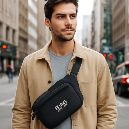 A modern traveler standing on a bustling city street, holding a sleek crossbody bag with RFID shielding visible. Alt: traveler with RFID crossbody bag in city setting.